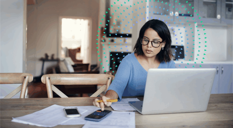 Woman working at computer with calculator