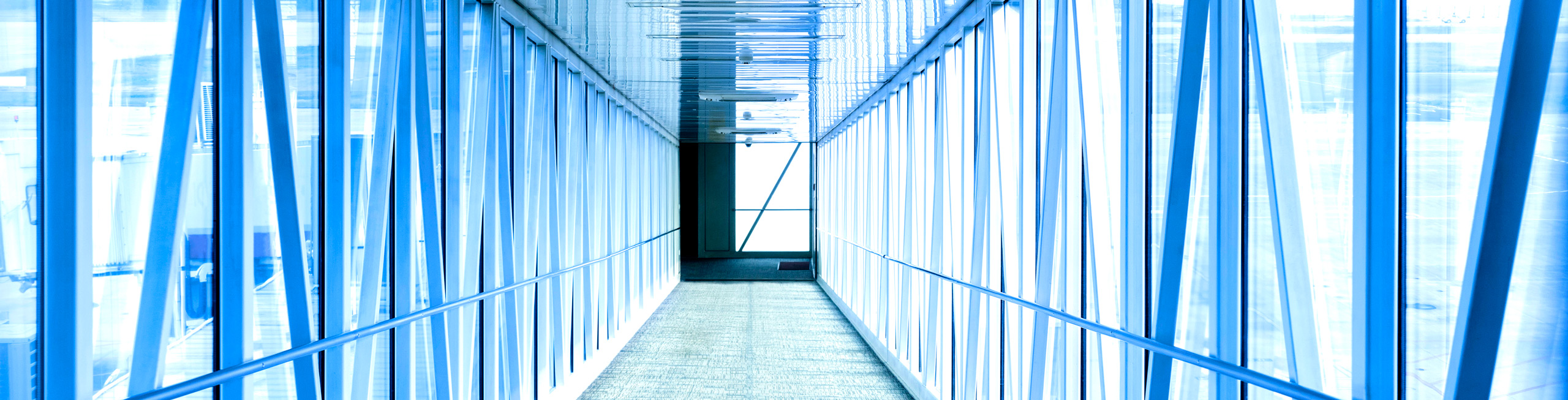 inside of industrial skywalk in blue tones