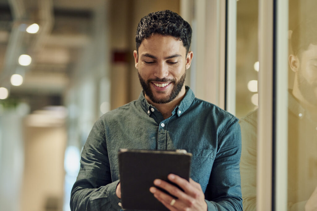Confident Businessman Using Tablet at the office