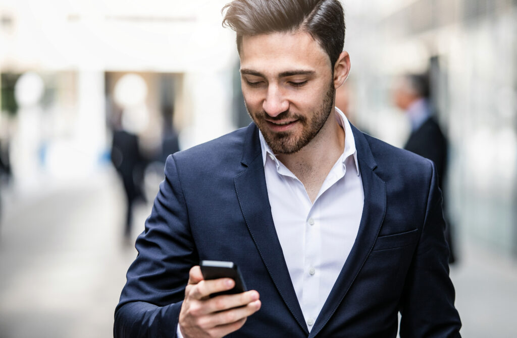 Businessman Looking at the Mobile Phone