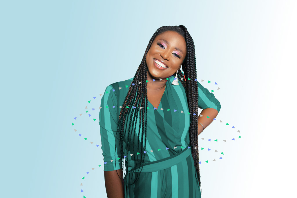 african american woman with braided hair similing in green dress
